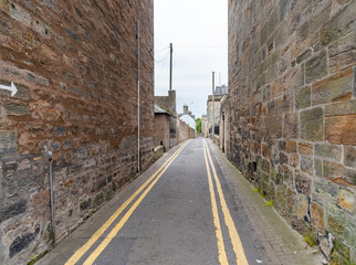 narrow street with high stone walls
