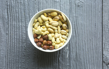 Assortment of nuts on a dark wooden table. View from above