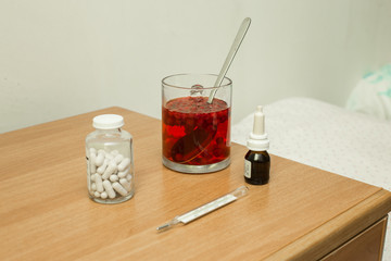 medical set on the nightstand with cranberry mors © Valeriy