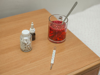 medical set on the nightstand with cranberry mors © Valeriy