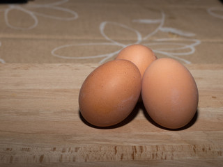 three eggs on the wood table