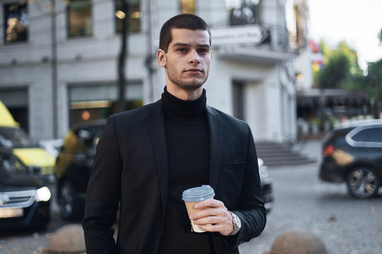 Young businessman going to the work with coffee