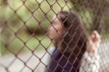 Blurred and soft focus of Teenager girl holding cage was imprisoned make no freedom,concept of lack...