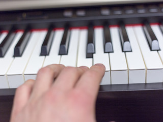 Fototapeta na wymiar Playing on classic electrical piano keyboard
