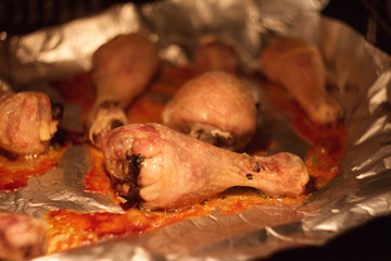 Abstract composition for designers with hot grilled fowl leg dish on foil in oil