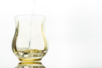 Close up of a fresh drink of water from a bottle in the studio on a white background