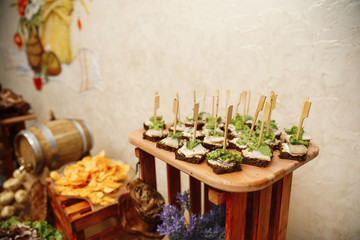 Catering banquet table with different food snacks and appetizers