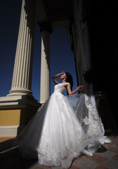 Fototapeta premium Elegant wedding salon is waiting for bride. Happy bride before wedding. Wonderful bridal gown. Beautiful wedding dresses in boutique. woman is preparing for wedding. Extremely happy. Bride to be