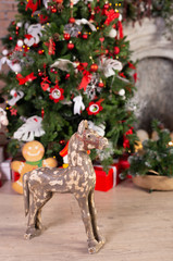 Wooden horse in front of the christmas tree. Free space.