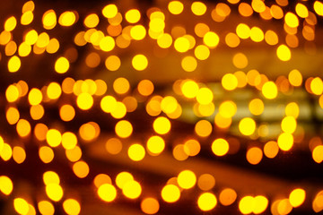 beautiful blurred garland on a yellow background with small circles