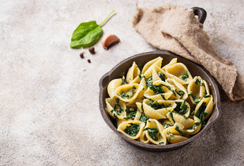 Conchiglioni pasta with spinach in creamy sauce