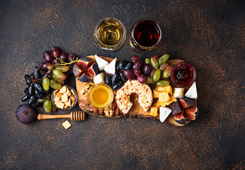 Cheese plate with grapes and wine