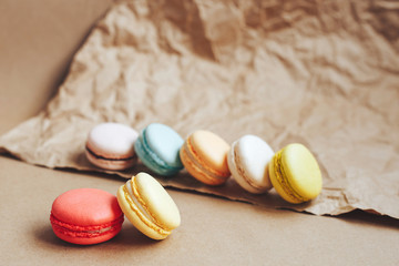 multicolored tasty macaroons are on brown kraft paper