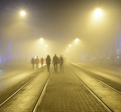 walk along the pavement on the night street in Helsink