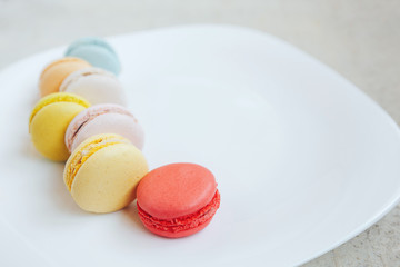 multi-colored macaroons on a white plate