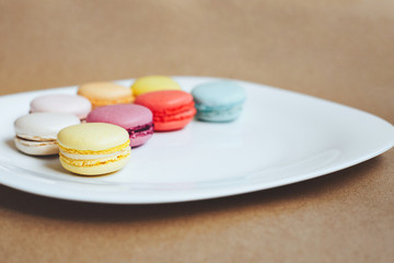 multi-colored macaroons an a white plate
