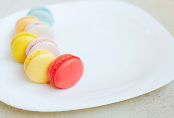 multi-colored macaroons on a white plate
