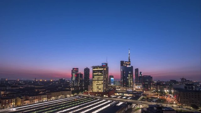 Milan skyline skyscrapers view time lapse video from night to day.