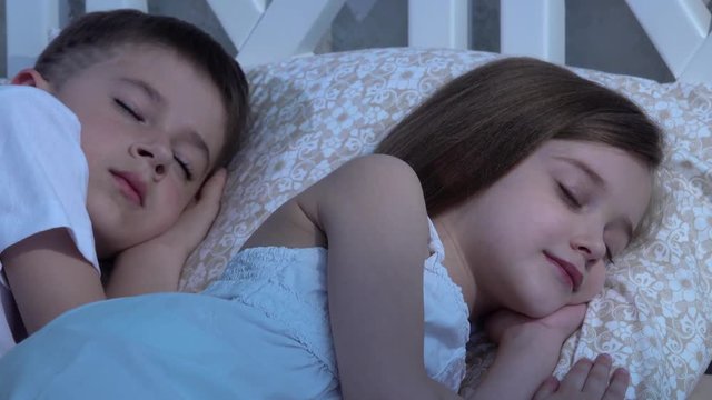 Children are sleeping on the bed. Close-up