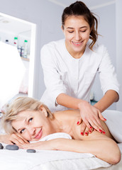 Fototapeta na wymiar Woman having professional massage in spa salon