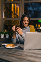Student taking online lessons in cafe