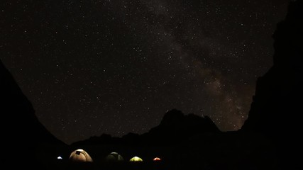 Time lapse of starry sky in the mountains. Camp climbers under the starry sky. - Powered by Adobe