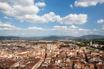 Fototapeta na wymiar Beautiful cloudscape over historical center with narrow streets, ancient Tuscany houses and river of Florence, Italy. UNESCO World Heritage Site