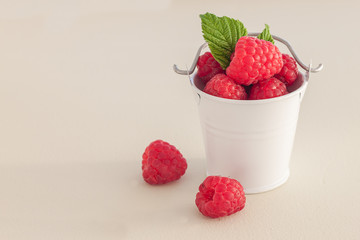 Raspberry in bowl. Raspberry on blue bacground with copy space for text.