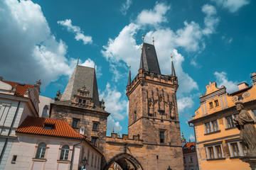 Gothic tower of the charles bridge aganst the blue sky in Prague