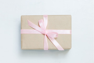 Gift box with rose on pink bacground.