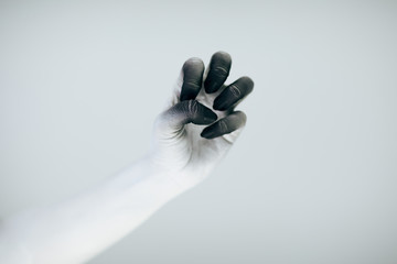 Creepy Halloween monster hand with white and black make up in front of white background
