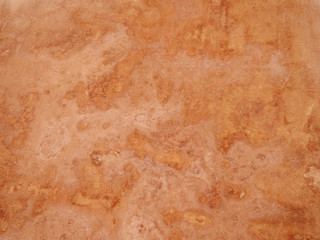 close up of a rough textured ocher stone wall background