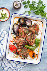 Barbecue t-bone lamb steak with carbonized onion and chili as top view in a white casserole