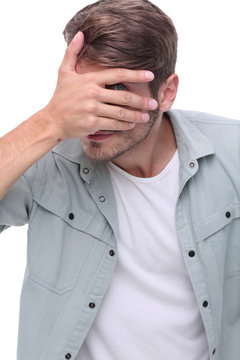 close up.young man covering his face with his hands