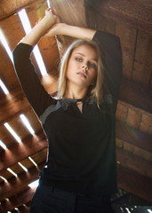 Portrait of a beautiful young woman with long curly hair. Photo of an incredibly beautiful face of a Caucasian model looking at the camera.