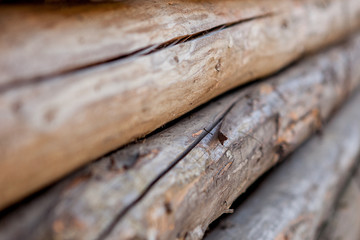 Folded wooden brown and gray planks in a sawmill. Piled alder boards as texture