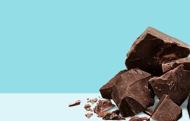 Close-up broken chocolate bar isolated on white