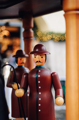 Wooden crib figurines of the three kings, maria and joseph of traditional German Glockenspiel, a christmas decoration, at the Christkindles Market in Nuremberg, Bavaria during snow in December