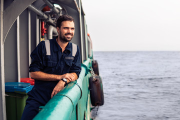 Marine Deck Officer or Chief mate on deck of vessel or ship . Marine life. He is smiling