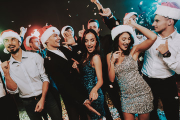 People in Santa Claus Cap Celebrating New Year.