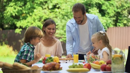Father bringing just delivered pizza to hungry family, smelling fragrant food