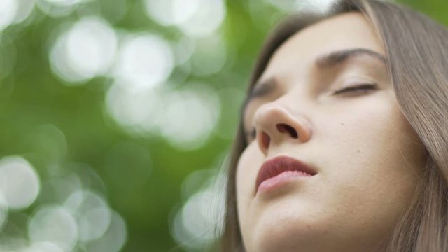 Woman face with closed eyes contemplating meditating low angle place for ad text