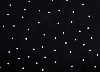 texture of silk fabric. background. white polka dots on a black background. Delicate black and white silky fabric, polka dot background © volody10