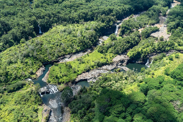 Areial view of multiple waterfalls in a single location near Hilo, on Hawaii's Big Island. Green...