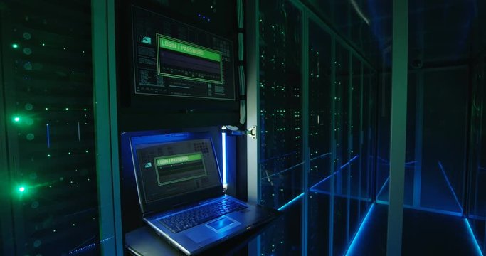 Close up shot of a computer login screen in a modern data center then appear message ddos attack