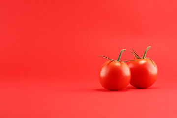 tomato on red background. italian healthy vegan food concept with tomatoes.