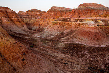 Rainbow City, Wucai Cheng. Colorful Red, Pink, Orange and Yellow landforms in the desert area of Fuyun County - Altay Perfecture, Xinjiang Province Uygur Autonomous Region, China. Rainbow Mountains
