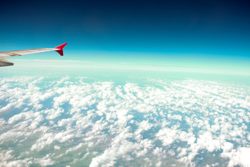 Fototapeta na wymiar Cloud blue sky view aircraft wing airplane window.
