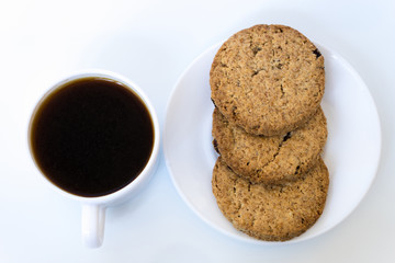 cup of coffee and cookies on a plate isolated on white