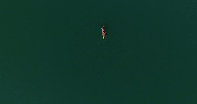 Man in kayak navigating the Tagua Tagua lake and its surroundings on a sunny day